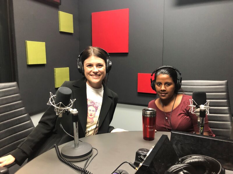 Samantha Moore with Ramya Amuthan sitting in a recording booth