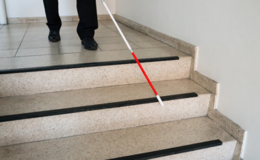 Person walking with a white cane