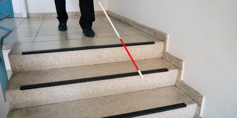 Person walking with a white cane