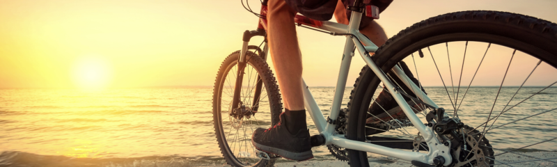 photo of a bike facing the sunset