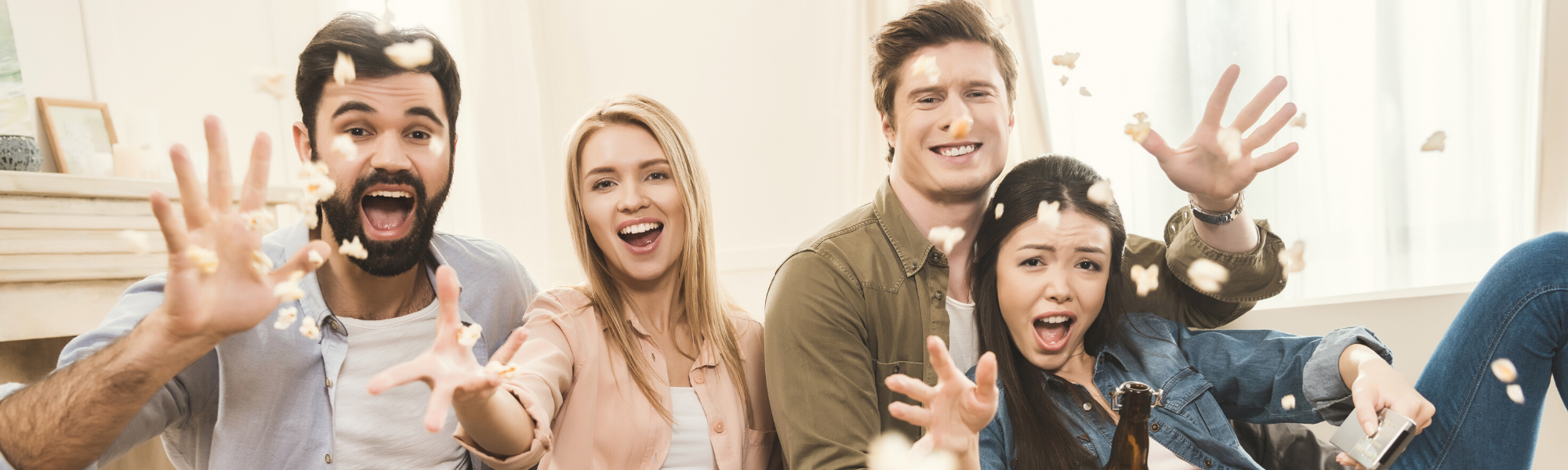 diverse group of people siting on couch laughing