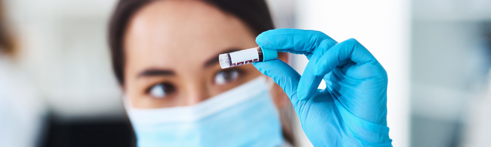 close up of scientist holding up treatment bottle