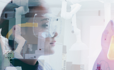 image of female scientist holding lab tools