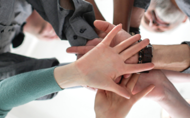 Image is of hands joined together in 