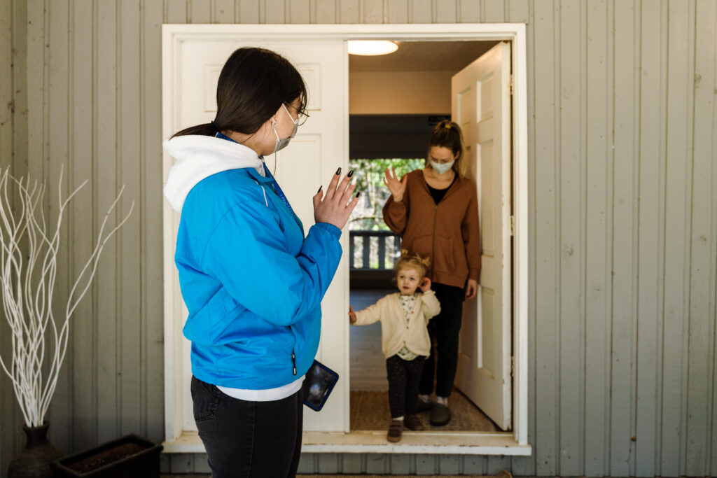 Image is of Global Faces representative speaking with a citizen