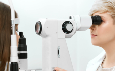 Image is of an eye doctor examining a patient.