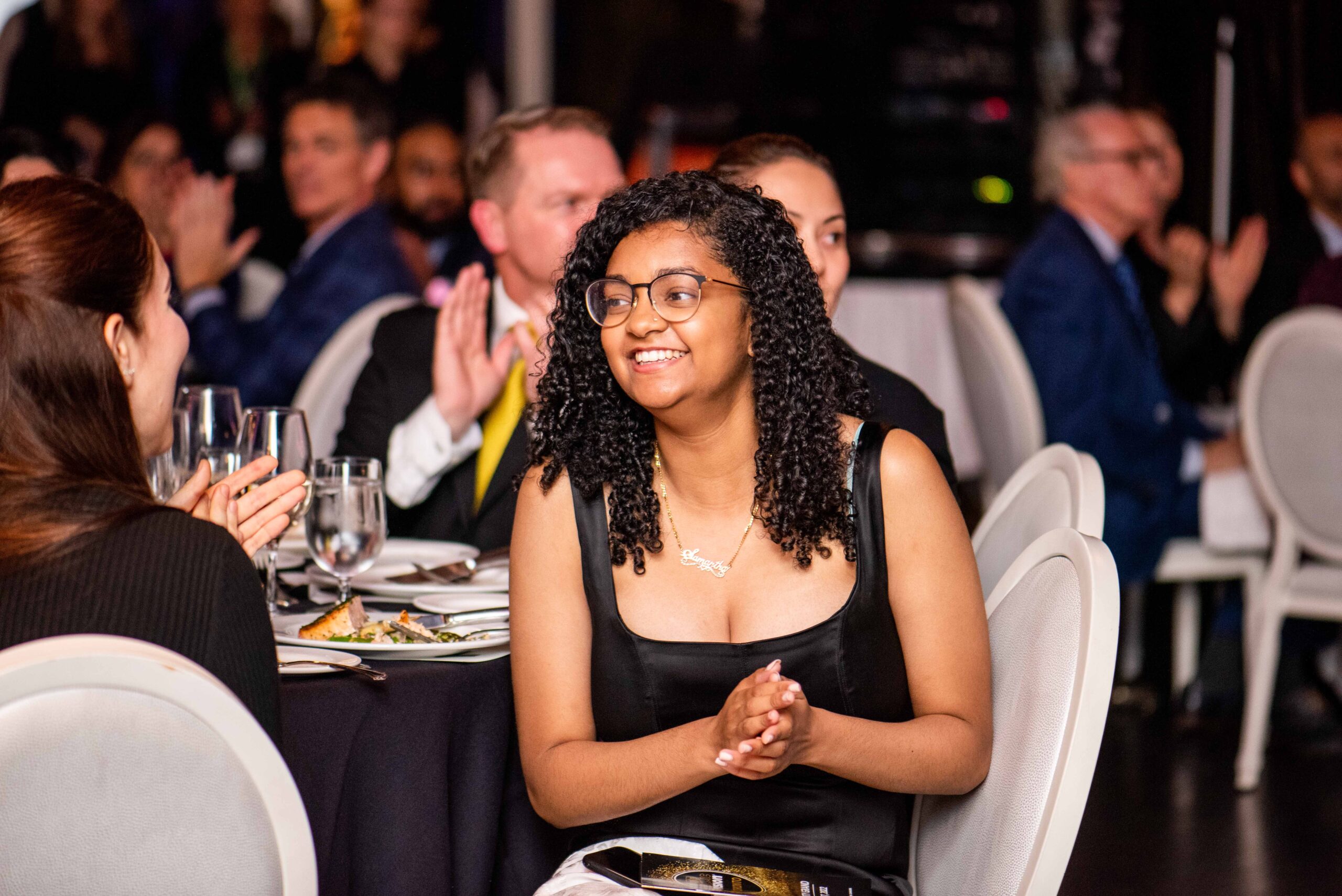 Image is of a Comic Vision event attendee laughing and clapping.