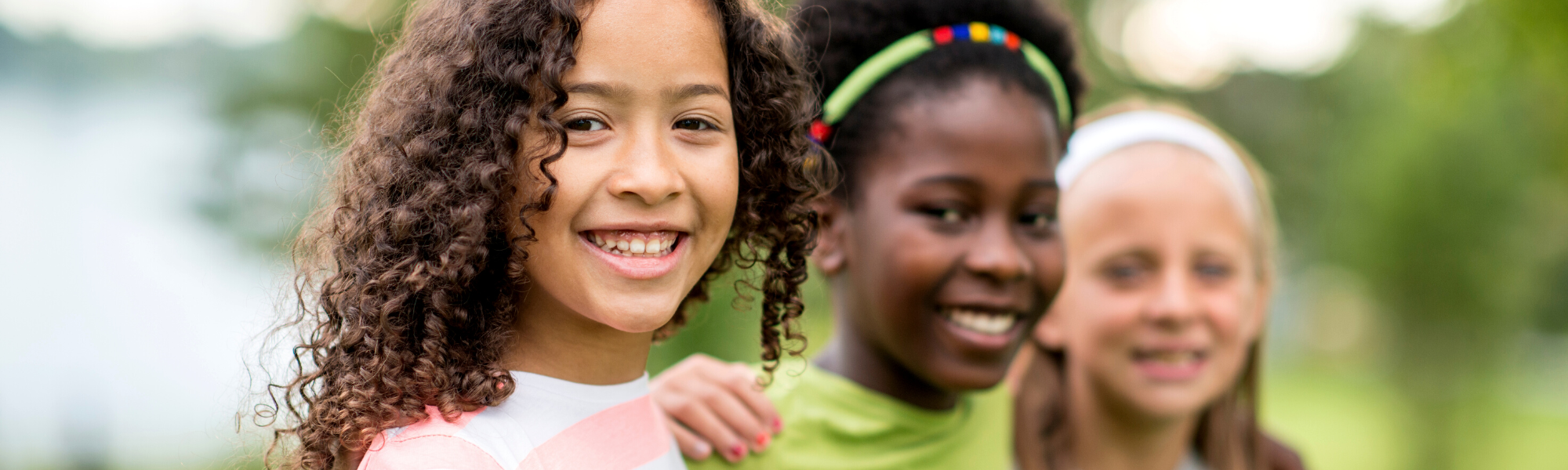 Image is of girls smiling.