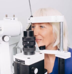 Image is of mature patient having her eyes examined.