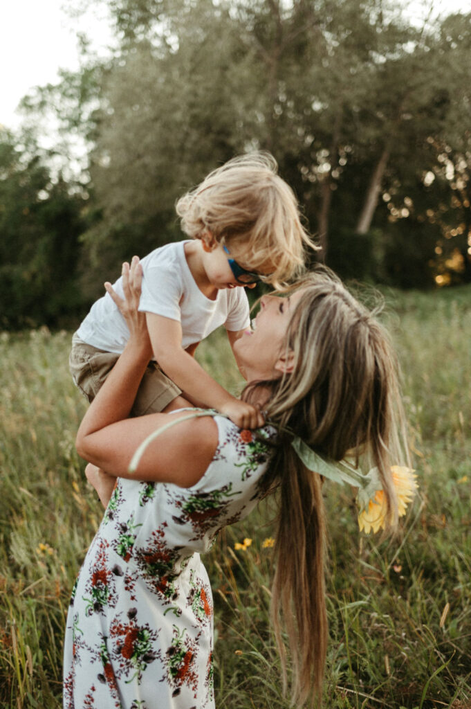 Image is of Jo-Anne lifting her son Darian into the air.