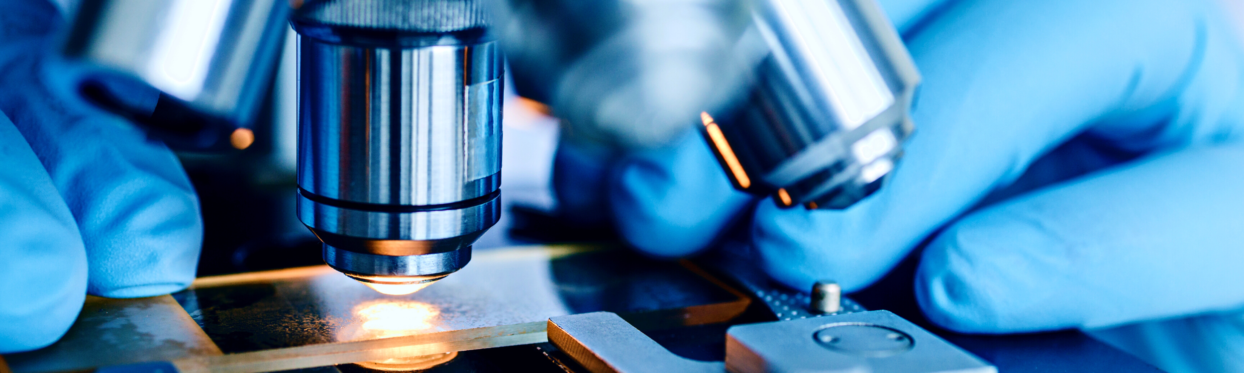 Image is a close-up of a medical microscope.