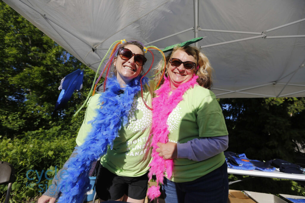 Image is of two Cycle for Sight Volunteers wearing funny costumes during the event.