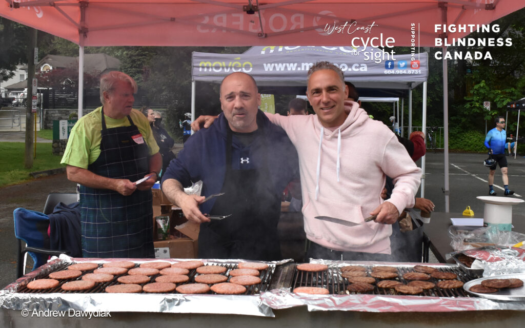 Image is of 2 event volunteers barbequing during Cycle For Sight events.