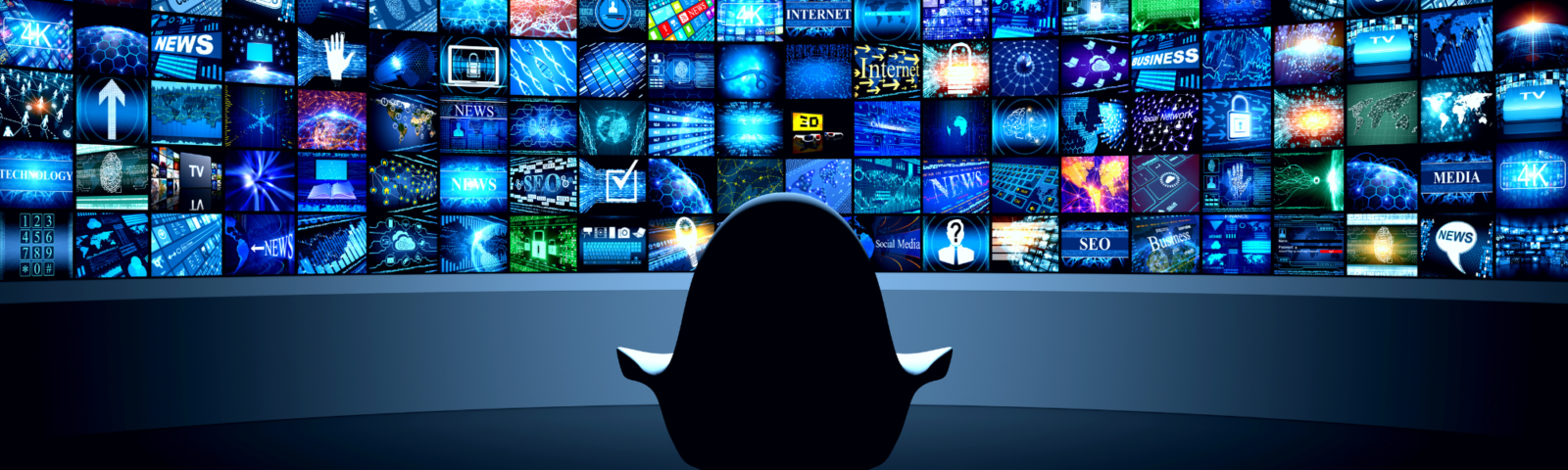 Image is of a chair seating in front of a wall of television monitors displaying a variety of programs.