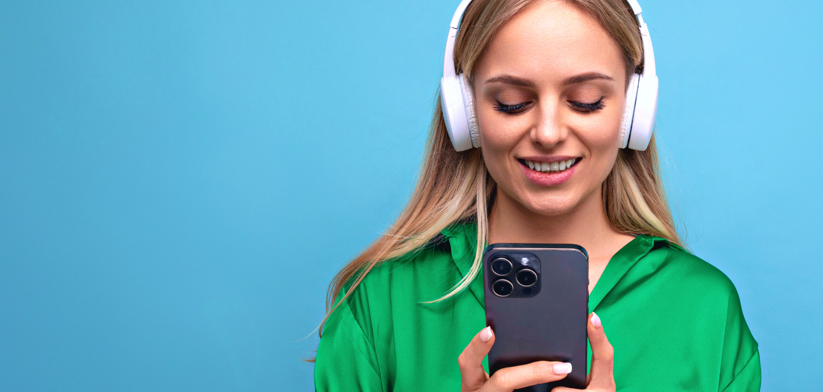 Image is of a woman listening to a podcast through her mobile phone whilst wearing headphones.