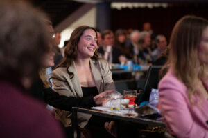 Image is of close-up of audience members smiling during presentations held at Comic Vision.