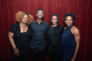 Image is of guest speaker, Adam Brown with family members.