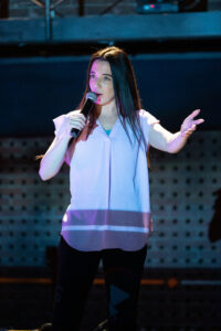 Image is of comedian performer, Anjelica Scannura.