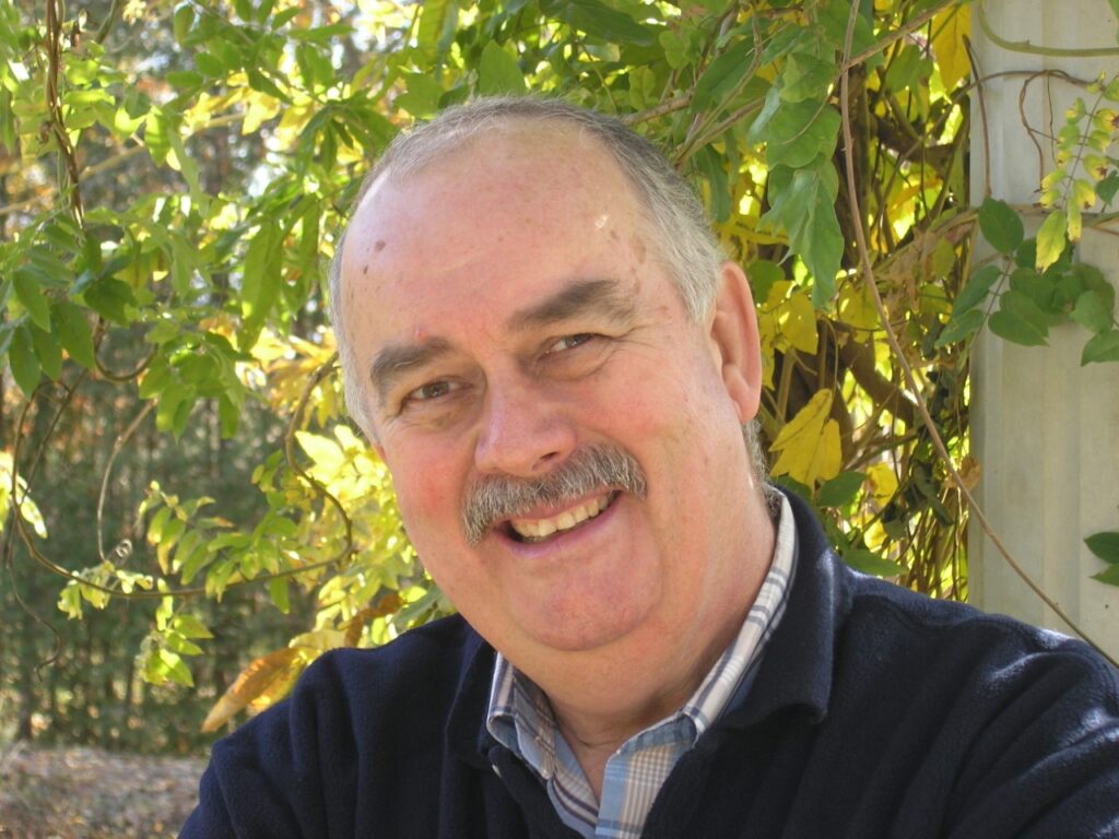 Image is of Ron Champion smiling outdoors.