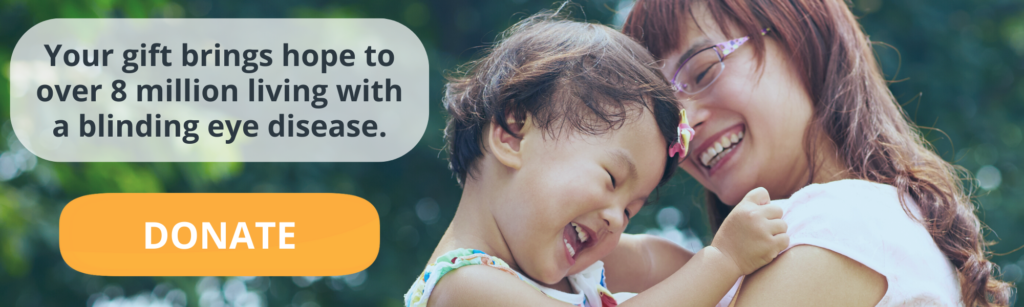 Image is of a mother holding her child, smiling, with text overlaid on the image that states, "Your gift brings hope to over 8 million living with a blinding eye disease."