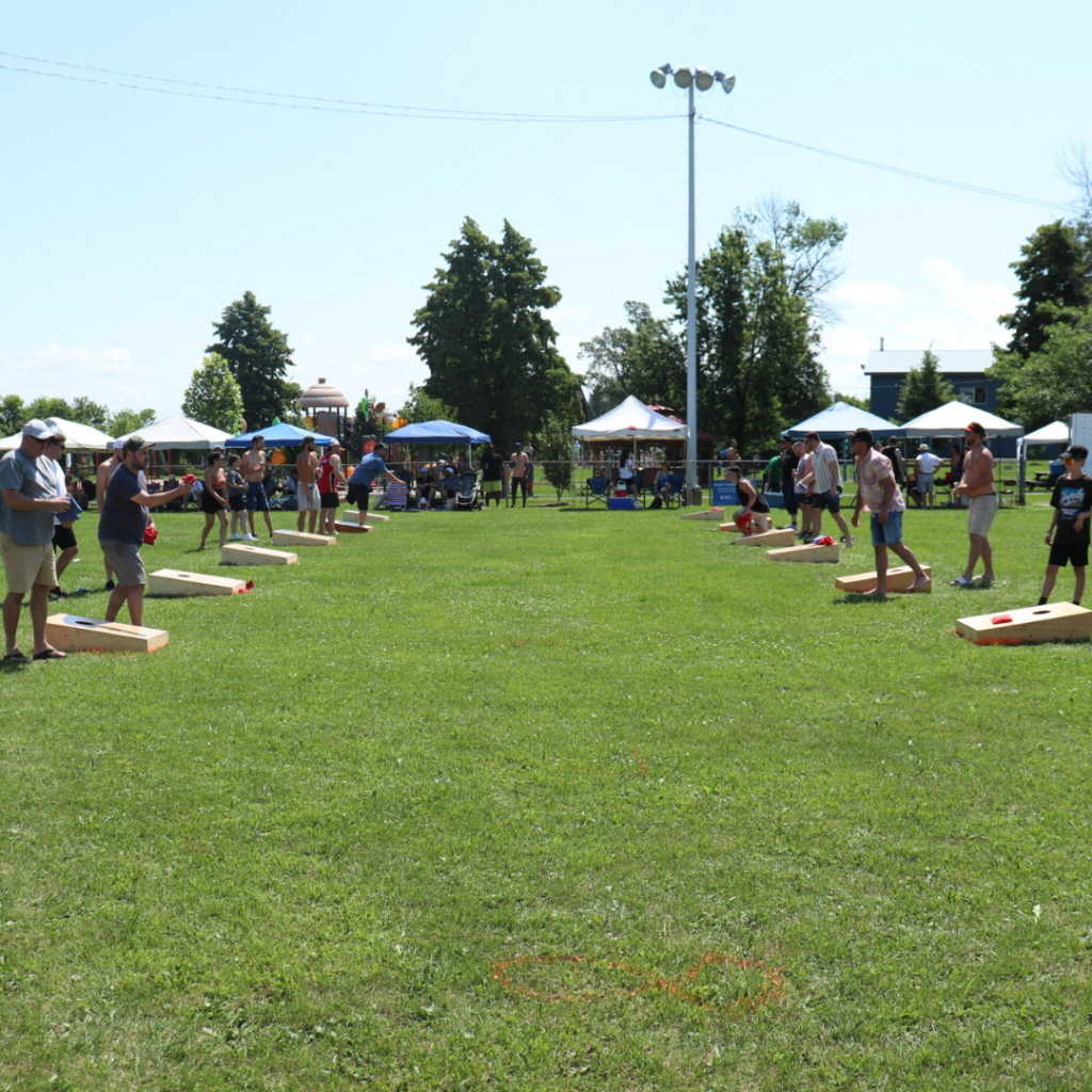 a wide photo showing the cornhole tournament.