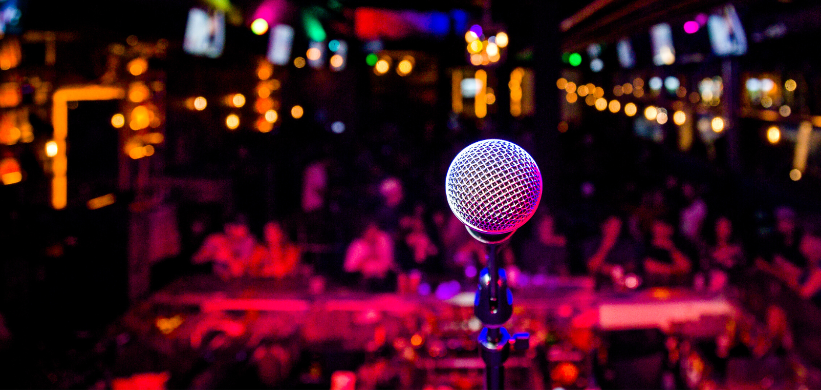 image of microphone in night club theatre style setting.