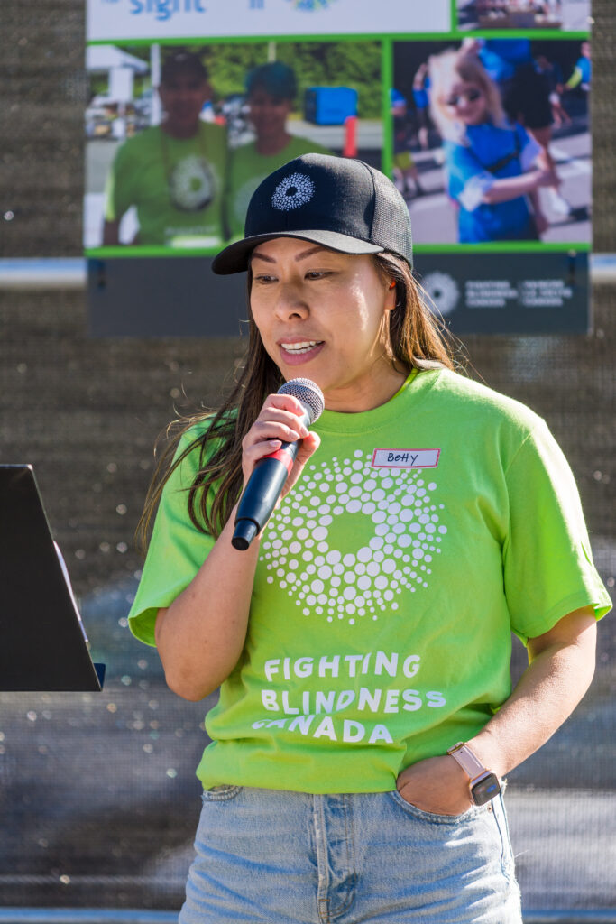 Volunteer hosting Cycle for Sight and using a microphone
