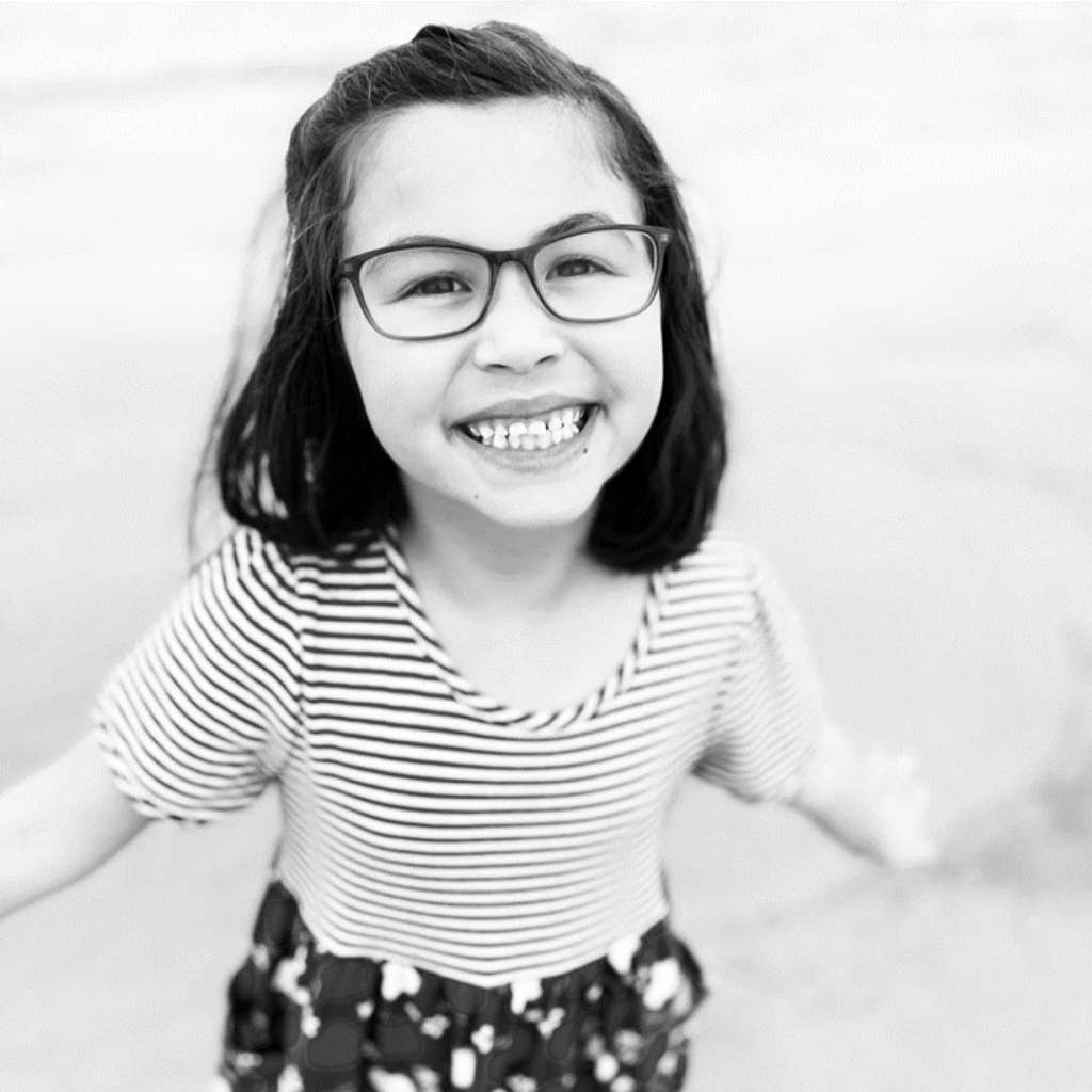 Image is of Violet, smiling, wearing DOT eyeglasses. 