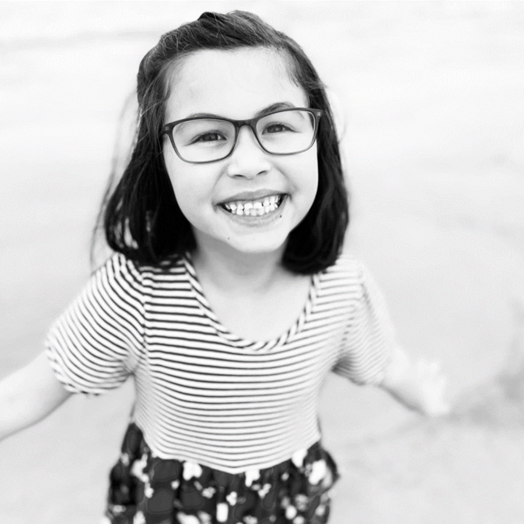 Image is of Violet, smiling, wearing DOT eyeglasses.