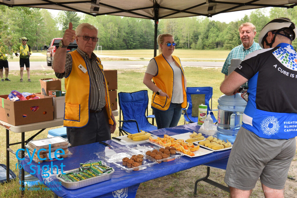 The Lions Club rest stop volunteers smiling and waving.