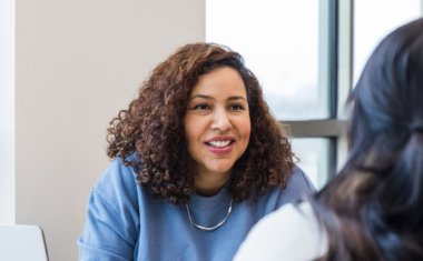 image of a mentor speaking to two mentees.