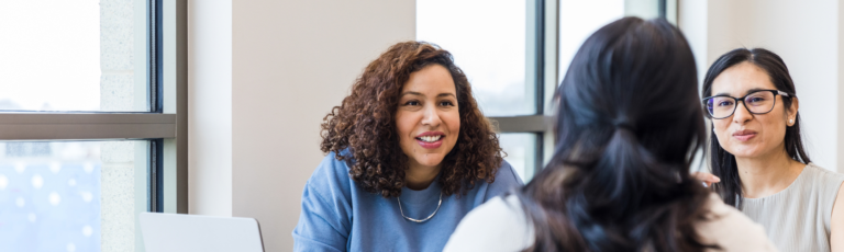 image of a mentor speaking to two mentees.