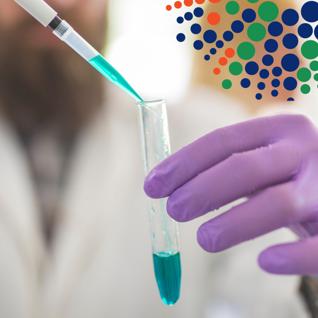 scientist putting liquid into a test tube