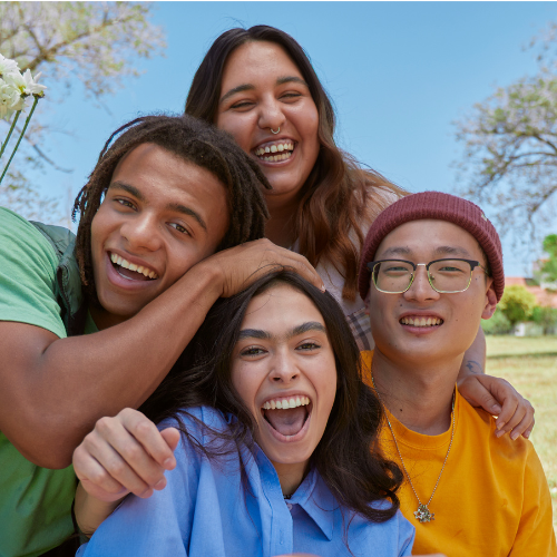 A group of youth smiling at the camera.