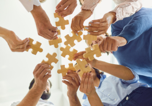 people putting puzzle together