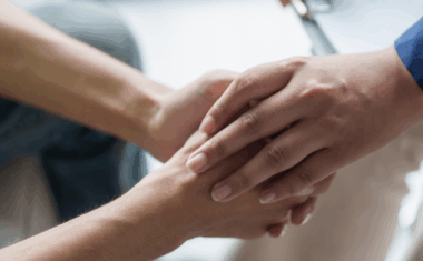 One person taking another's hands