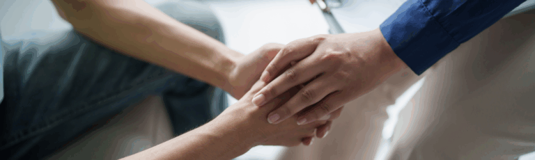 One person taking another's hands