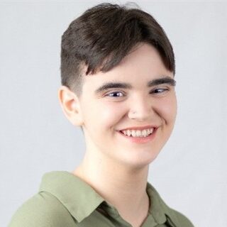 Headshot of Elliot Gibson in a green shirt
