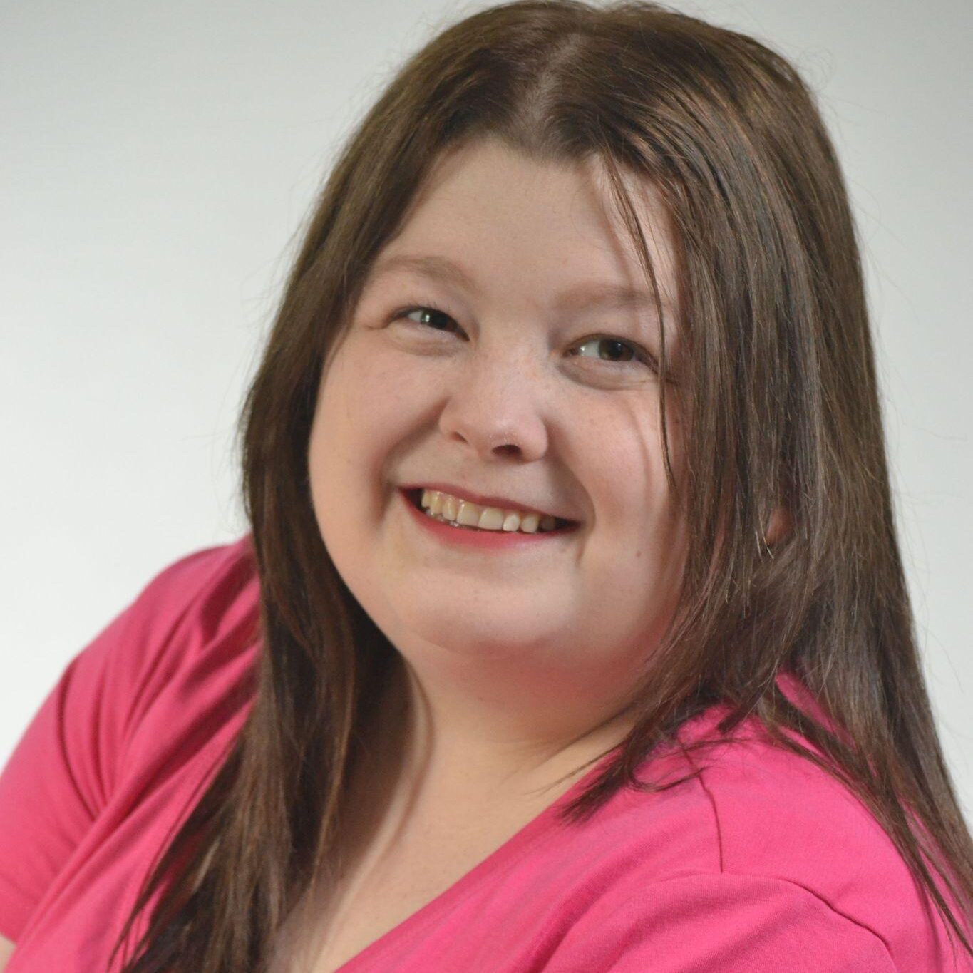 Headshot for Alicia Grace Chernier wearing a pink shirt.