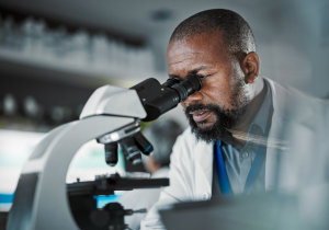 scientist looking in microscope