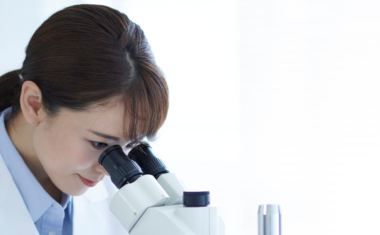 Scientist looking through a microscope