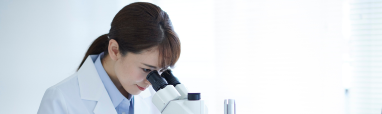 Scientist looking through a microscope