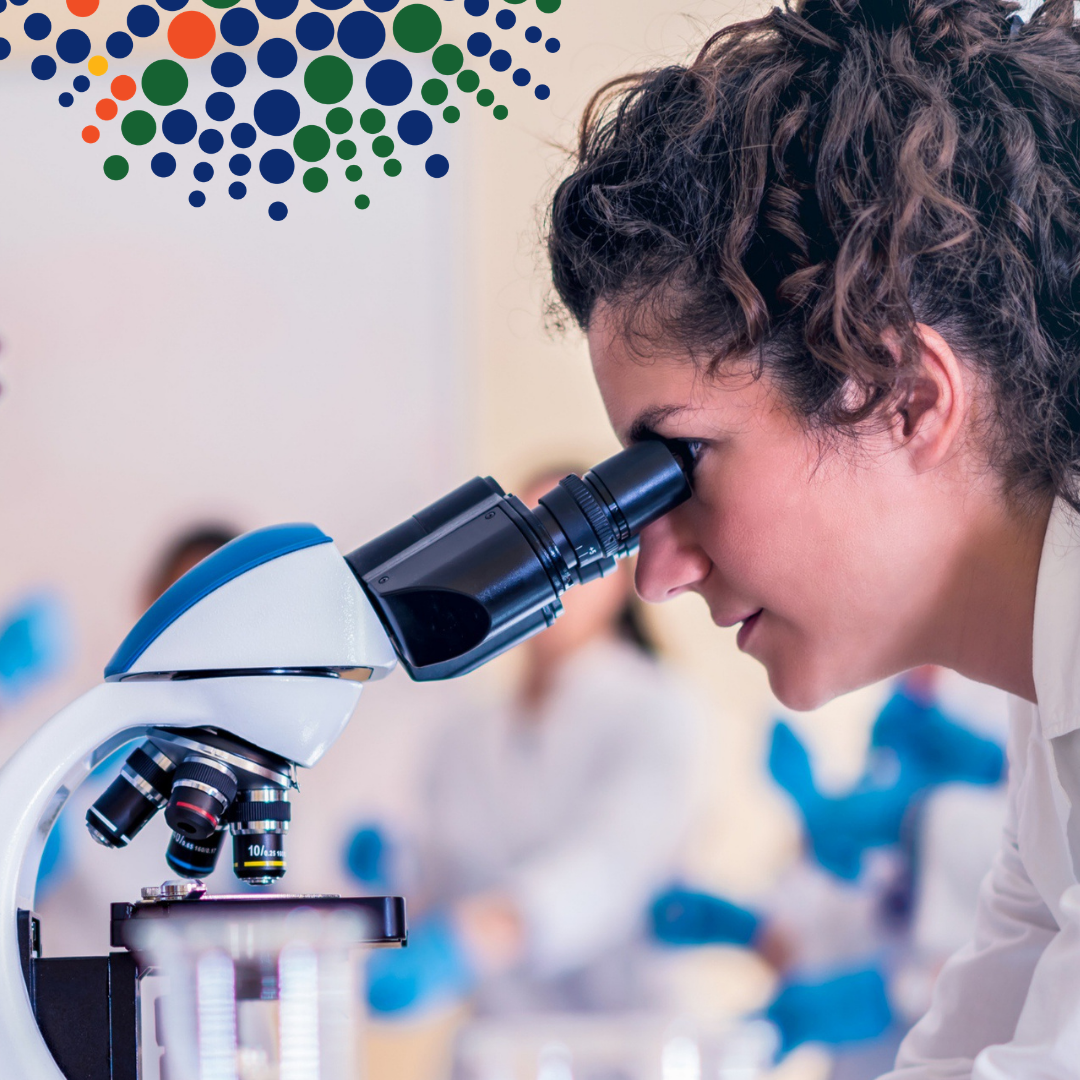 Scientist looking through a microscope